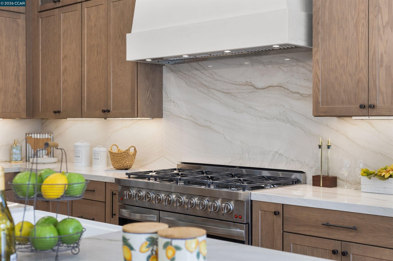 Wood kitchen cabinets and drawers surrounding the range in the Lancaster residence