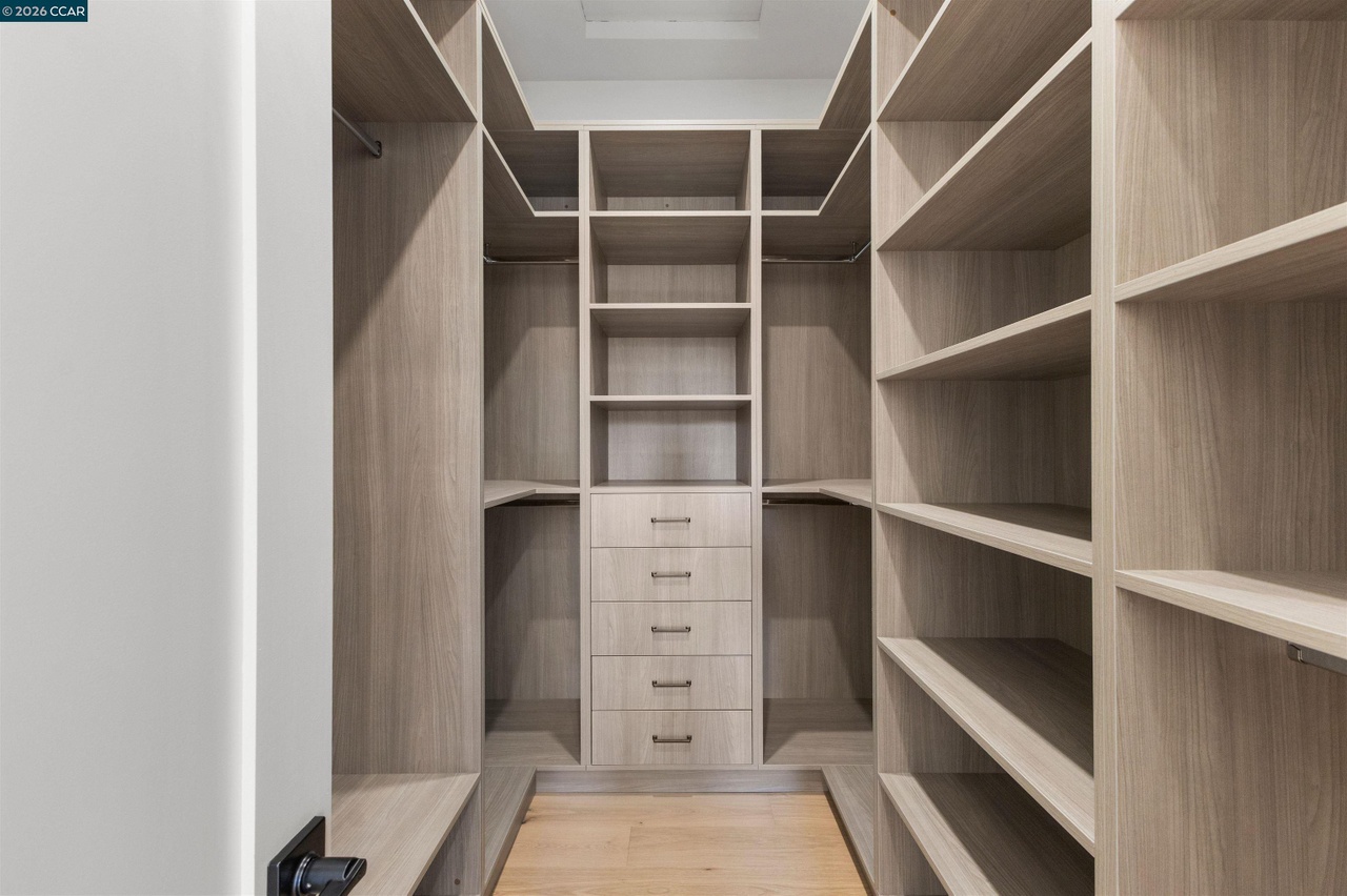 Lancaster walk-in closet with floor-to-ceiling shelving, hanging rails and central storage